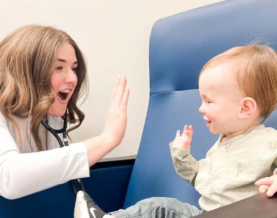 nurse practitioner and toddler high fiving